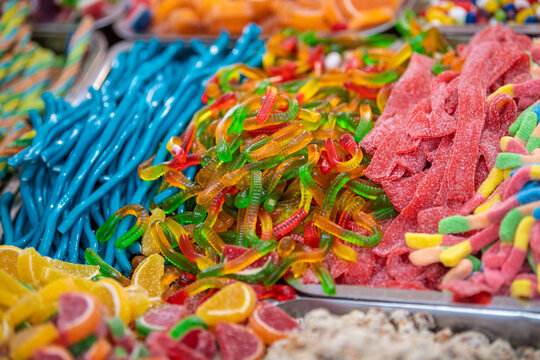 Assorted gummy candies and jellies on street market shop. A lot of colorful jelly sweets candy flavor. Lots of colorful sweets, candies background.