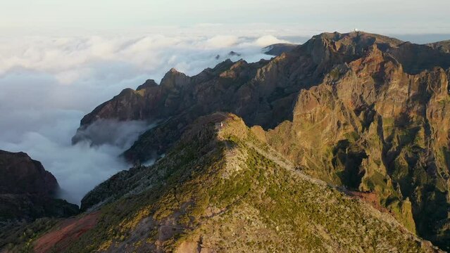 Amazing sunset over the highest mountain on the volcanic island of Madeira called Pico Ruivo. Aerial video in 4K.