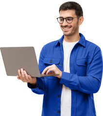 Young stylish man wearing casual blue shirt, standing with opened laptop, surfing online or typing