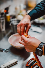 hand of chef in restaurant cooking crab leg