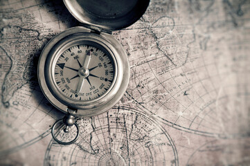 Fototapeta na wymiar antique brass compass and old map of the world