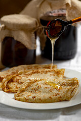 honey close-up dripping on homemade pancakes