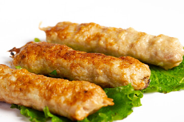 closeup of chicken lula kebab on white background