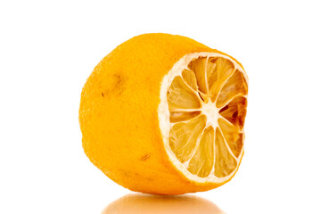 One cut dried lemon, macro, isolated on white background.