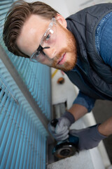 high-angle view of man using angle grinder