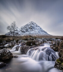 Glencoe, Scottish highlands landscape of snow covered mountains and waterfalls near Fort William. Glencoe mountains and bacjgrounds