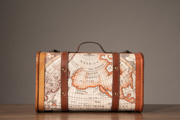 Wooden retro suitcase with world map on it