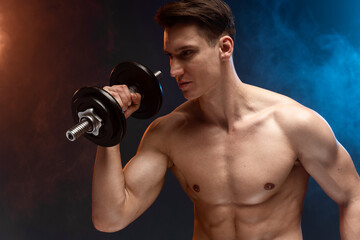 Fototapeta na wymiar Photo of young man with good physique isolated on black background