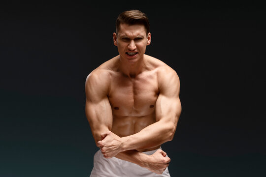 Portrait of bare-chested muscular sportsman isolated on black background