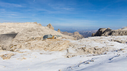The mountain hut Refugio Boè in the Dolomites mountains on a beautiful late autumn day