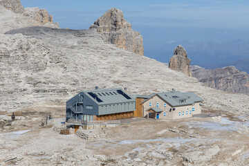 The mountain hut Refugio Boè in the Dolomites mountains on a beautiful late autumn day