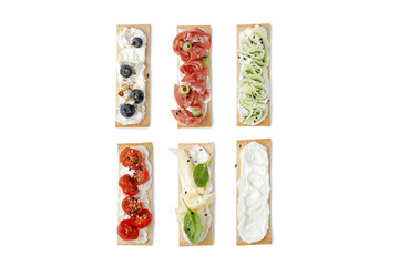 Set of assorted sandwiches on grain crispbreads, snack, toasts, bruschetta with cream cheese, salami, cucumber, blueberry.