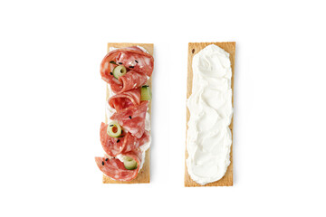 Sandwich, toast on grain crispbread with cream cheese, sliced salami sausage, cucumber isolated on white background. Snack, bruschetta.