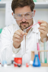 man working with laboratory pipette