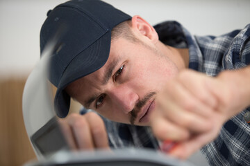 close up of worker holding a screwdriver