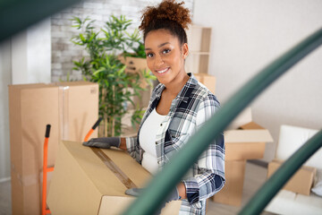 young happy woman moving in new place