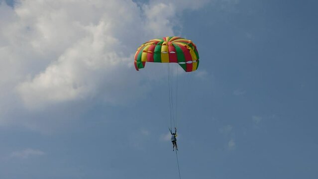 Unidentified person on parasailing parachutes with blue sky landscape view, Pattaya, Thailand
