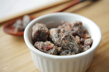 Himalayan black salt rock crystals, Kala Namak in a container on table 