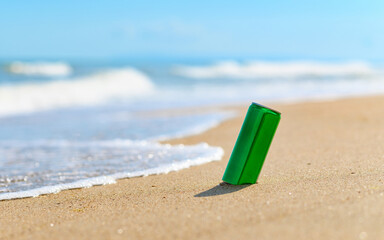 Aluminum can with a drink on the seashore.