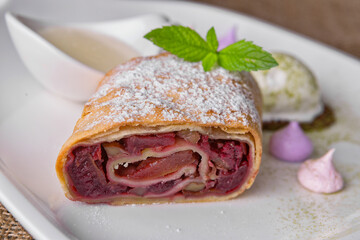 Baked strudel with apple, cherries and nuts