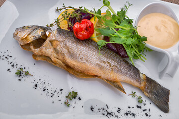 Fried seabass fish with vegetable and lemon sauce