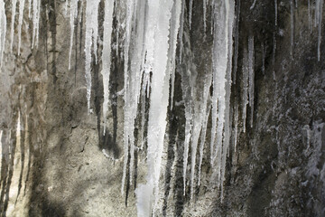 Icicles on the slope of the rock.