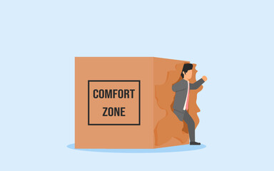 OUT OF COMFORT ZONE CONCEPT.A BUSSINESS MAN BREAKING OUT THE BOX. OUT OF LIMITS TO FIND NEW CHALLENGE AND GROW