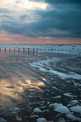 Wadden sea at low tide, North sea beach landscape, coast on Romo island in Denmark at sunset,...