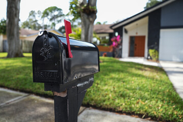Black mailbox in front of a house - Powered by Adobe