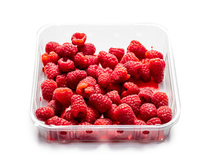 Fresh raw raspberry on a plastic tray and white isolated background. Fruit product for sale.