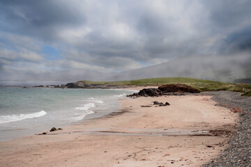 Beautiful Renvyle beach in county Galway, Ireland, Mountains and clouds in the background. Irish landscape.