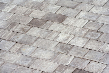 Gray paving stones. Paving surface road. Texture made of big gray cement bricks. Brick stone street road - pavement texture
