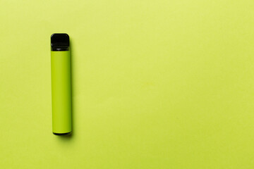 Disposable electronic cigarette on color background, top view