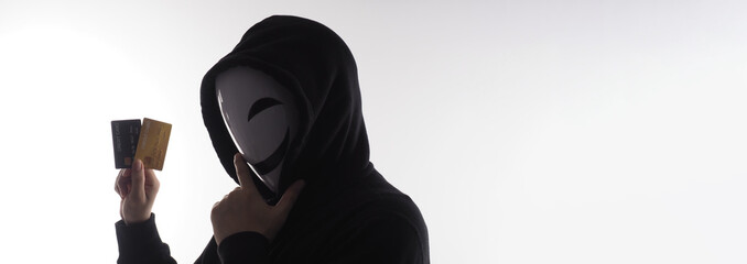 Hacker man and credit cards in hand. Represent credit cards personal data stolen by anonymous man...