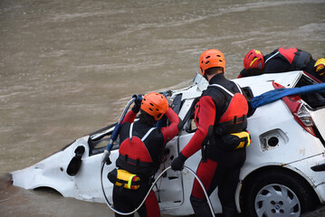 Firefighters and divers recover a driver's car that ended up in a lake or river after a terrible...