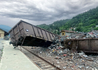 Massive freight train derailed along the tracks. Tracks, freight trolleys, wheels and sleepers...