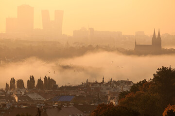 Naklejka premium Modern and Historical - Prague, Bohemia, Czech Republic at sunrise , Vysehrad in mist