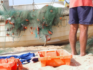 Fish caught in a fisher net with a fisherman