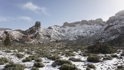 Fototapeta na wymiar Teide National Park view on a snowy day in December 2022, Tenerife, Canary Islands, Spain, volcanic mountains covered with snow 