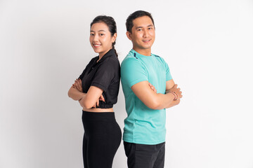 asian man and woman smiling standing back to back on isolated background