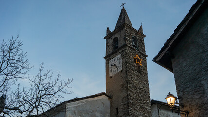Fototapeta na wymiar Pontechianale – Chianale close up, small church with clock, Italy, Piedmont