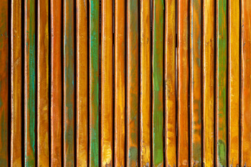 Pattern formed by thin vertical wooden slats with rustic paint