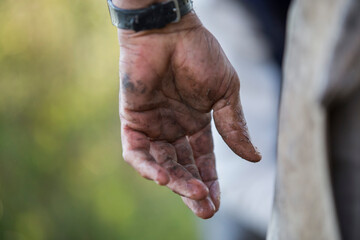 Dirty adult hand with mud