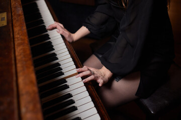 Fototapeta na wymiar Close up of young girls hands, playing piano.