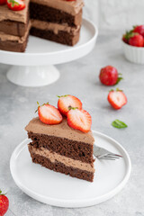 Naked chocolate cake with cream and fresh strawberries on top. Rustic style. Selective focus. Copy space.