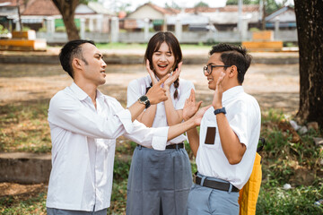 Two male high school students arguing with girls screaming in the background