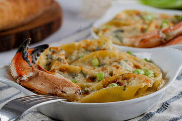  Pasta shells stuffed with a mixture of fresh local Jonah crab, spinach, ricotta, and alfredo sauce. Topped with Gruyere cheese and garnished with chopped scallions.