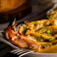  Pasta shells stuffed with a mixture of fresh local Jonah crab, spinach, ricotta, and alfredo sauce. Topped with Gruyere cheese and garnished with chopped scallions.
