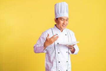 chef imagines inhaling delicious food while holding a serving plate on isolated background