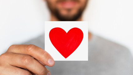 Man holding a red heart. Romantic man. Message. Love. The senses.